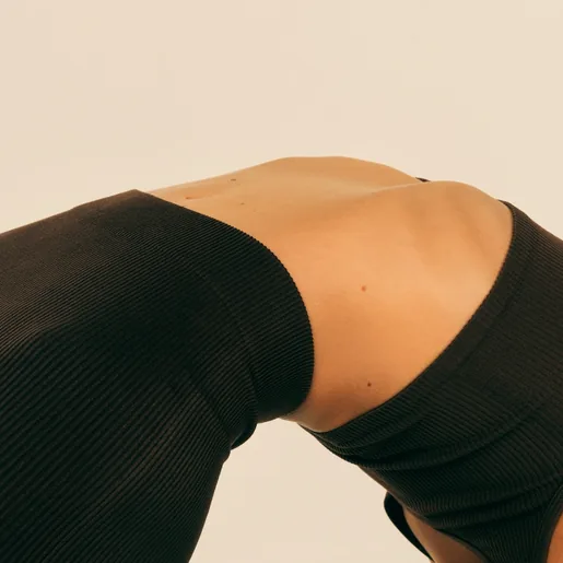 Stomach of woman arching backwards