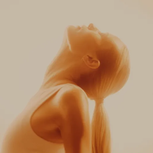 Woman in light looking upwards