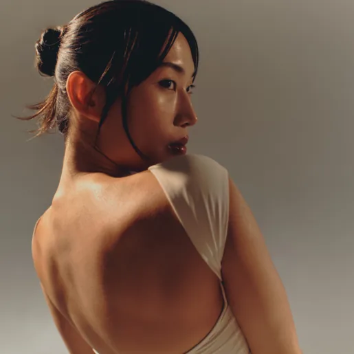 Woman in white looking over shoulder